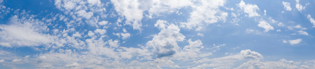 Naklejka na ściany i meble Panoramic view of blue sky with clouds and sunlight
