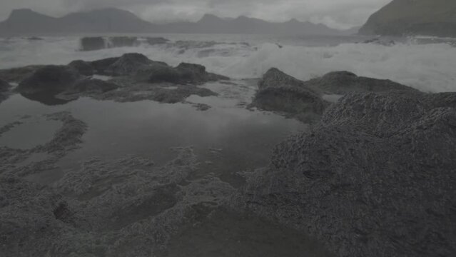 Portrait of a highlander portrait in Fjord, Faroe Island with gray cloudy sky