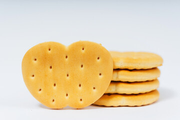 cookies in the form of an apple on a white background. flour crackers with holes for tea drinking. high-calorie flour sweets for the holiday