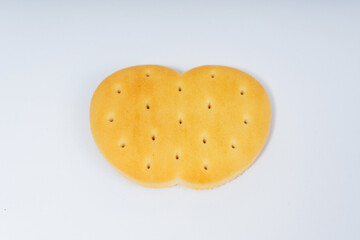 cookies in the form of an apple on a white background. flour crackers with holes for tea drinking. high-calorie flour sweets for the holiday