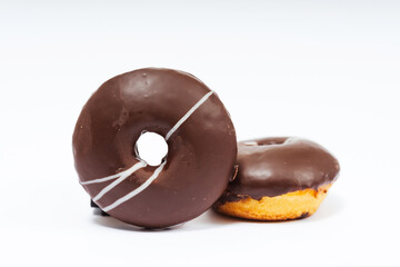 chocolate donuts on a white background. flour donuts with chocolate icing on a light background. colorful pastries