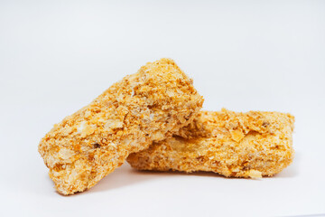 small sweet cupcakes with sprinkles on a white background. Napoleon cake cut into pieces on a light background. small cakes sprinkled with crumbs