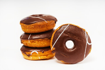 chocolate donuts on a white background. flour donuts with chocolate icing on a light background. colorful pastries