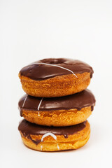 chocolate donuts on a white background. flour donuts with chocolate icing on a light background. colorful pastries