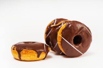 chocolate donuts on a white background. flour donuts with chocolate icing on a light background. colorful pastries