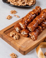 Vertical closeup shot of gourmet grape paste and walnut snacks on a table