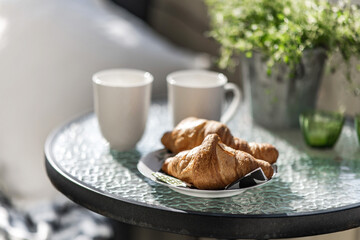 cup of coffee and croissant in morning time