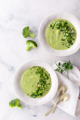 Broccoli green soup with fresh parsley. Healthy and diet vegan dish. Top view on stone table.