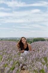 Cheerful young female in a lavender field on a sunny day