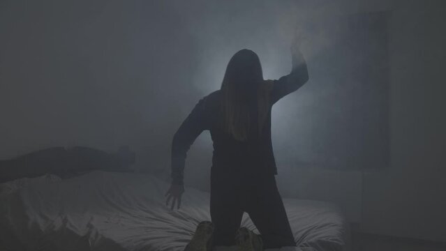 4k cinematic scary footage of a Silhouette girl with a possessed demon and fog and horror