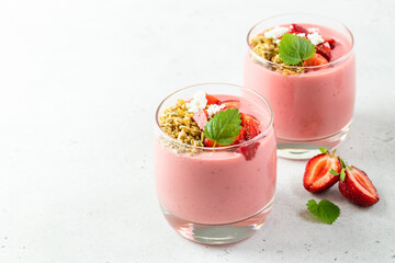 Strawberry banana oatmeal yogurt dessert in glasses. Copy space, flat lay.