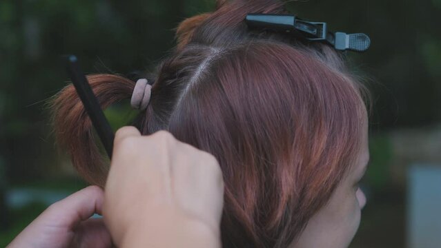 Process of weaving making boxer braids cornrows by a hair braider.