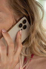 the phone is in the girl's hands near her ear