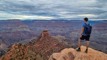 Man with scenic view from Ooh Ahh point on South Kaibab hiking trail at South Rim, Grand Canyon...