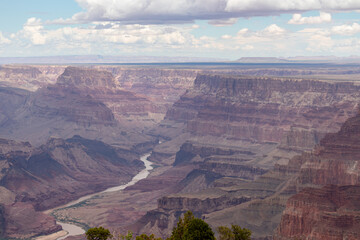 Fototapeta premium Panoramic aerial view seen from Desert View Point at South Rim of Grand Canyon National Park, Arizona, USA, America. Colorado River weaving through valleys and rugged terrain. Natural world wonder