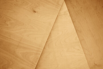 Plywood is made from thin sheets (veneers) of wood glued together, each with its grain in perpendicular directions in alternating layers to improve the strength. background of triangle frame