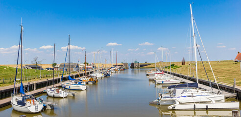 Fototapeta na wymiar Panorama of sailing yachts in the harbor of Termunterzijl, Netherlands