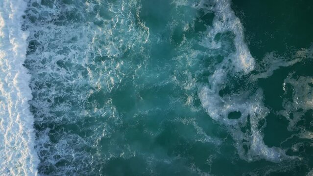 Aerial view over foamy waves in Gold Coast, Australia