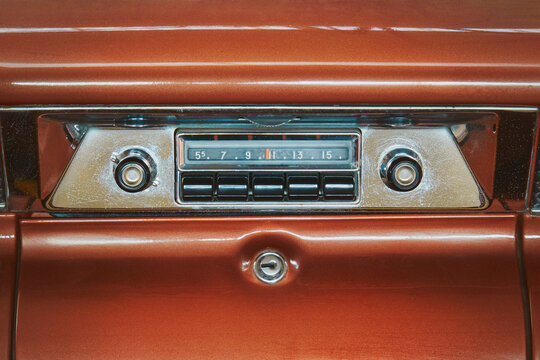 Old car radio inside a red classic American car