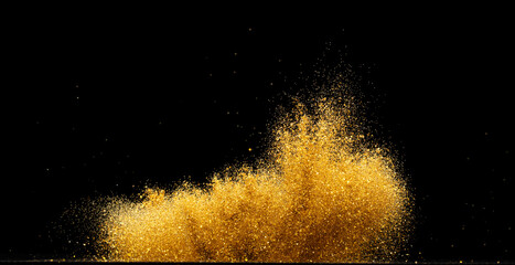 Explosion metallic gold glitter sparkle. Golden Glitter powder spark blink celebrate, blur foil explode in air, fly throw gold glitters particle. Black background isolated, selective focus Blur bokeh