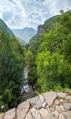 Summer mountains countryside view from Elenski Skok ancient small pedestrian stone bridge above stream in deep gorge. North Macedonia not far from Debar Town, Europe. © wildman