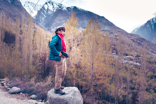 Asian woman tourism in Beautiful Landscape of Hunza Valley in blossom season. Northern Area of Pakistan.