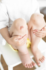 Wound on the girl's knee. The child fell and injured his knee. Scratch on the skin.