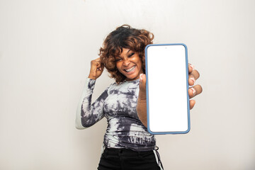 young african woman showing her phone screen and rejoices