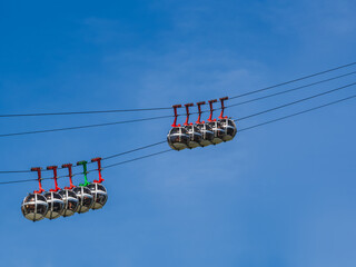 Gondola bubbles against the blue sky. Cable car taking tourists to Fort de La Bastille in Grenoble,...