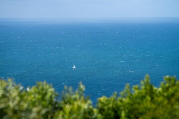 looking down at a yacht out at sea sailing in high winds. boat on the water near sydney nsw australia