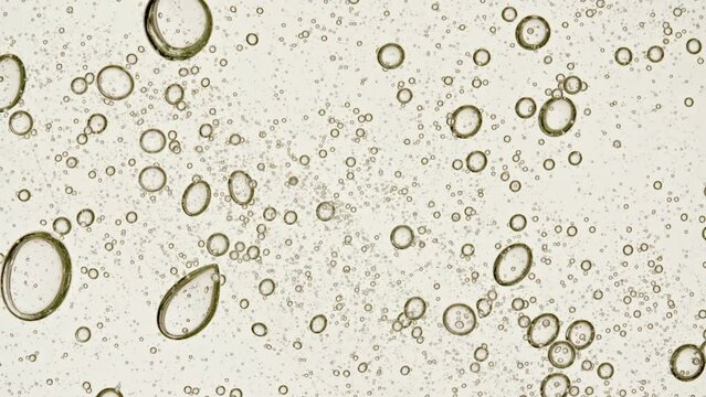 Transparent Cosmetic Gel Fluid With Molecule Bubbles and Oil Spreading on White Background. Macro shot. Production Close-up. Slow Motion. High quality 4k footage
