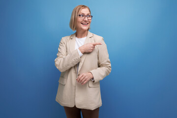 50s business woman in a stylish jacket on a bright studio background with copy space