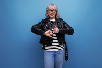 informal energetic healthy gray-haired woman 50s years old grandmother in a rocker jacket on a...