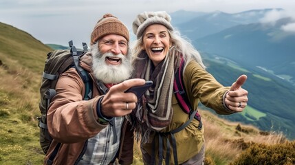 Happy smile elderly couple of hikers in the ascent to the summit take a selfie phone on the highlands landscape around