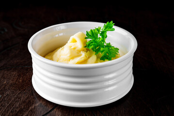 Fresh creamy mashed potato in white bowl on table