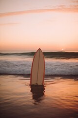 Orange and white surfboard standing on beach at sunset, created using generative ai technology