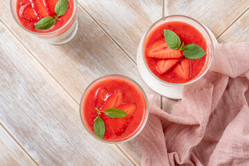 Italian dessert panna cotta in glass with strawberries.