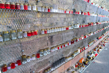many candles on the wall on the day of remembrance of the victims.