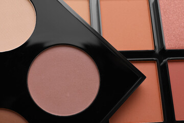 Colorful contouring palettes as background, closeup. Professional cosmetic product