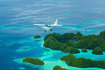 Aerial shot of Light aircraft flying over tropical islands in Micronesia