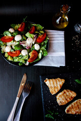 Salad with chicken fillet and lettuce. on a black background.