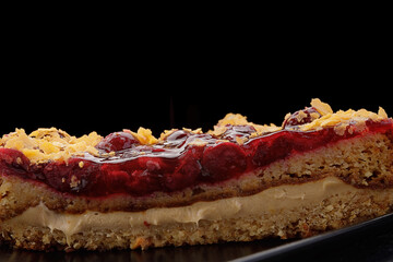 Cherry pie close-up on a black plate
