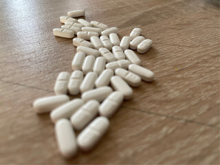 Fototapeta na wymiar pills on a wooden table