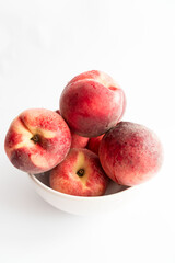 ripe peaches on a white background. top view. close up. fresh peaches in a bowl on a white background.