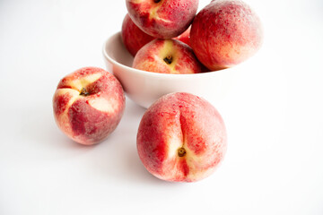 ripe peaches on a white background. top view. close up. fresh peaches in a bowl on a white background.