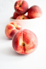 ripe peaches on a white background. top view. close up. fresh peaches in a bowl on a white background.