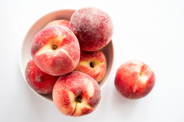 ripe peaches on a white background. top view. close up. fresh peaches in a bowl on a white background.