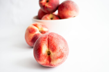 ripe peaches on a white background. top view. close up. fresh peaches in a bowl on a white background.
