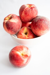 ripe peaches on a white background. top view. close up. fresh peaches in a bowl on a white background.