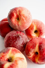 ripe peaches on a white background. top view. close up. fresh peaches in a bowl on a white background.